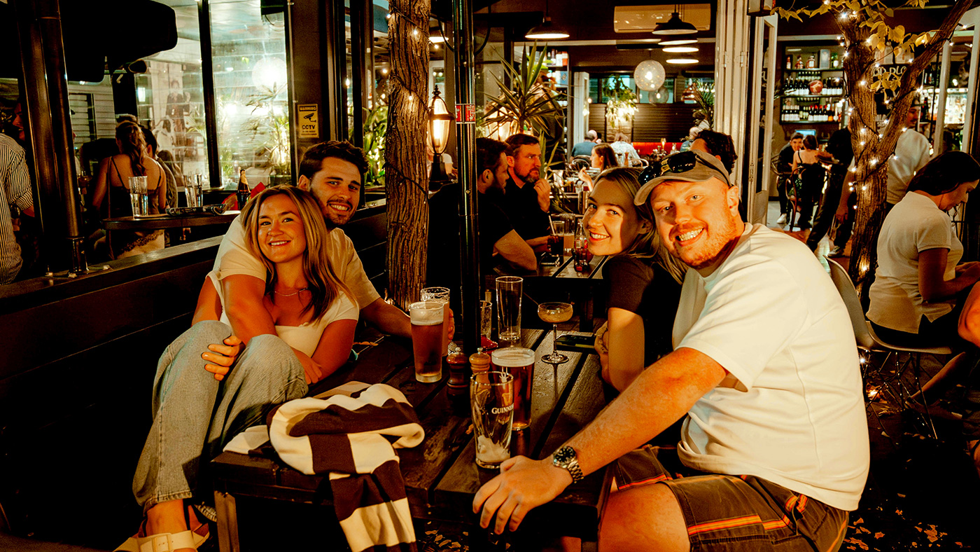 Friends smiling together while dining at Goat House